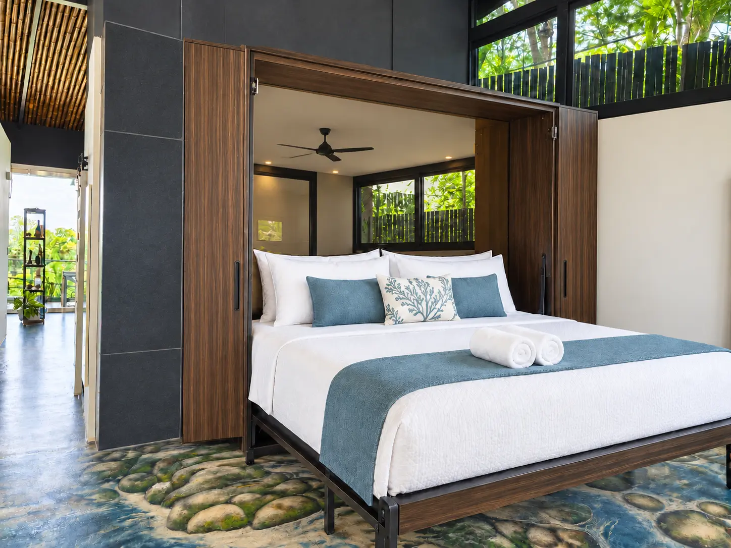 Rooftop Penthouse king bedroom with white bedding and ocean-blue accents at Hotel VOS