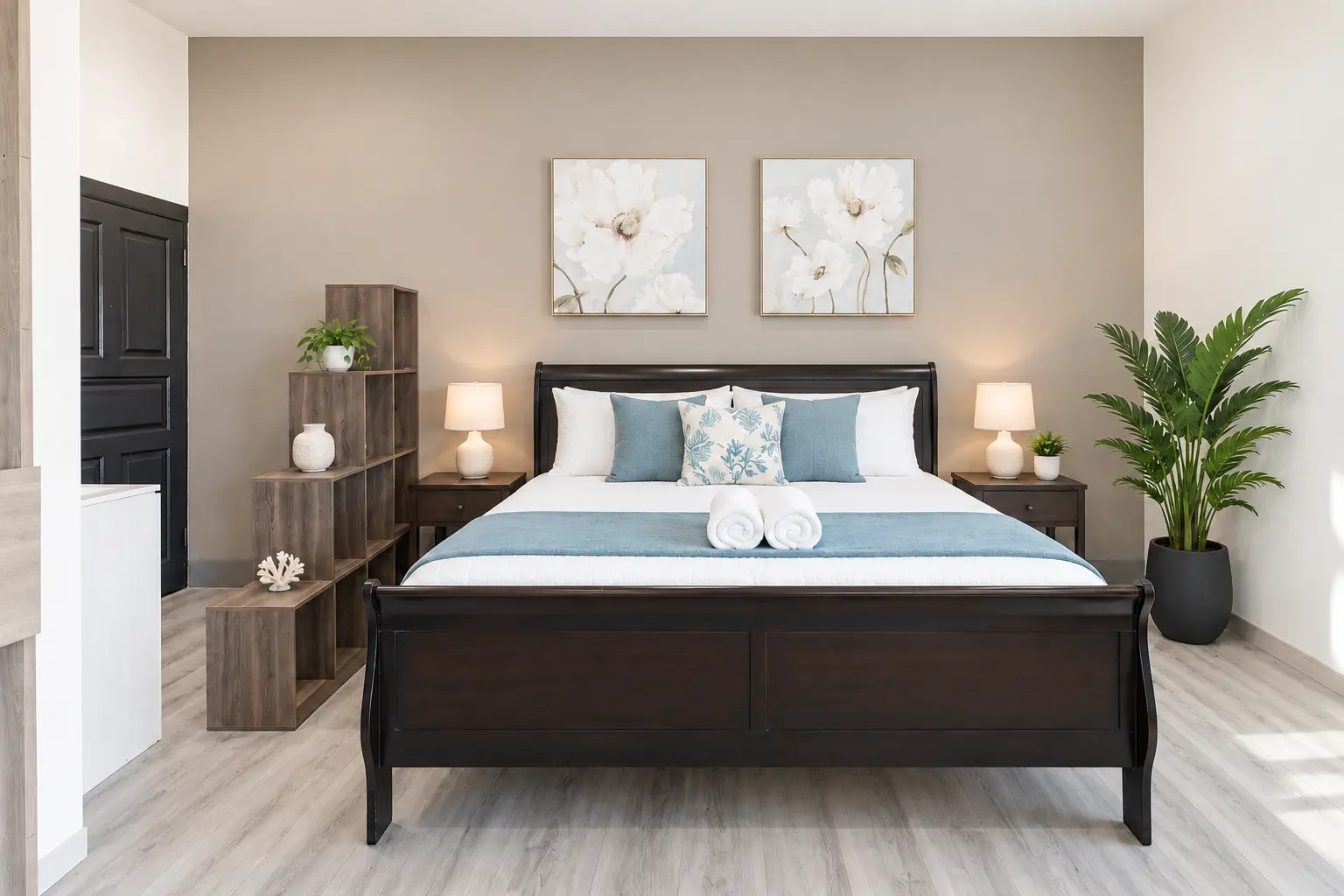 California king bed with white linens and ocean-blue accents in Suite 7